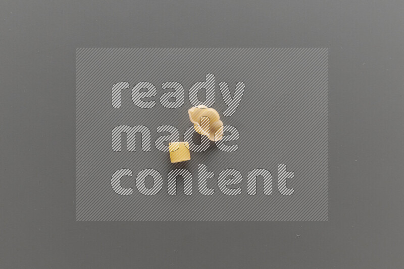 Big rings pasta with other types of pasta on grey background