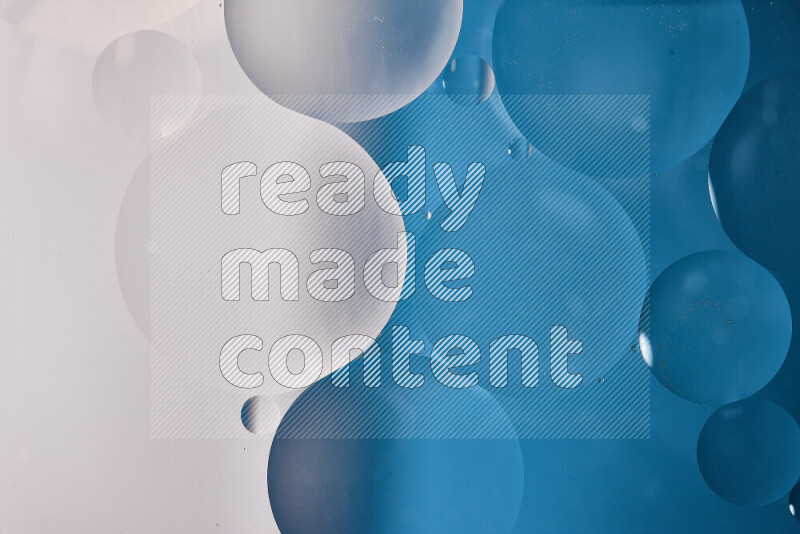 Close-ups of abstract oil bubbles on water surface in shades of white and blue
