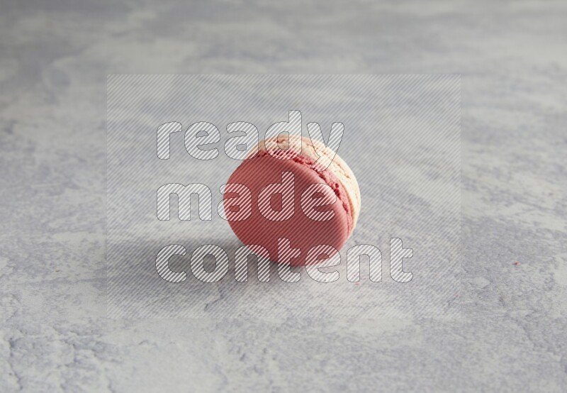 45º Shot of Pink Litchi Raspberry macaron on white  marble background