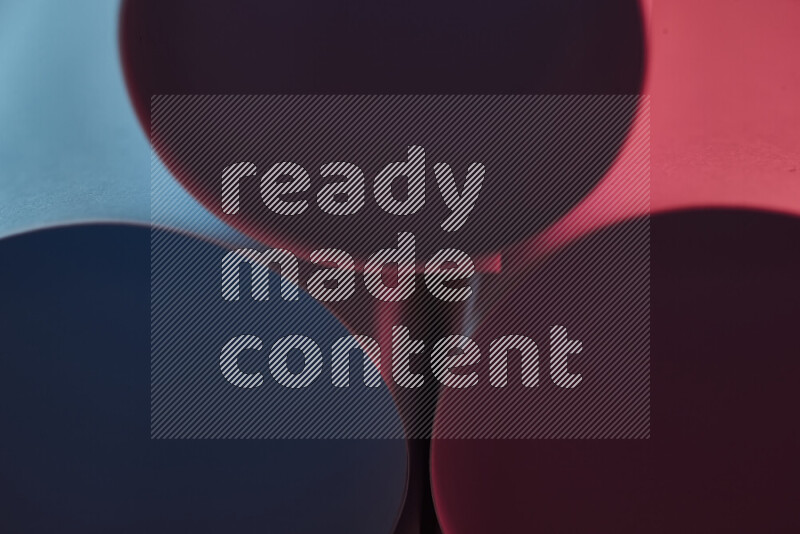 The image shows an abstract paper art with circular shapes in varying shades of blue and red