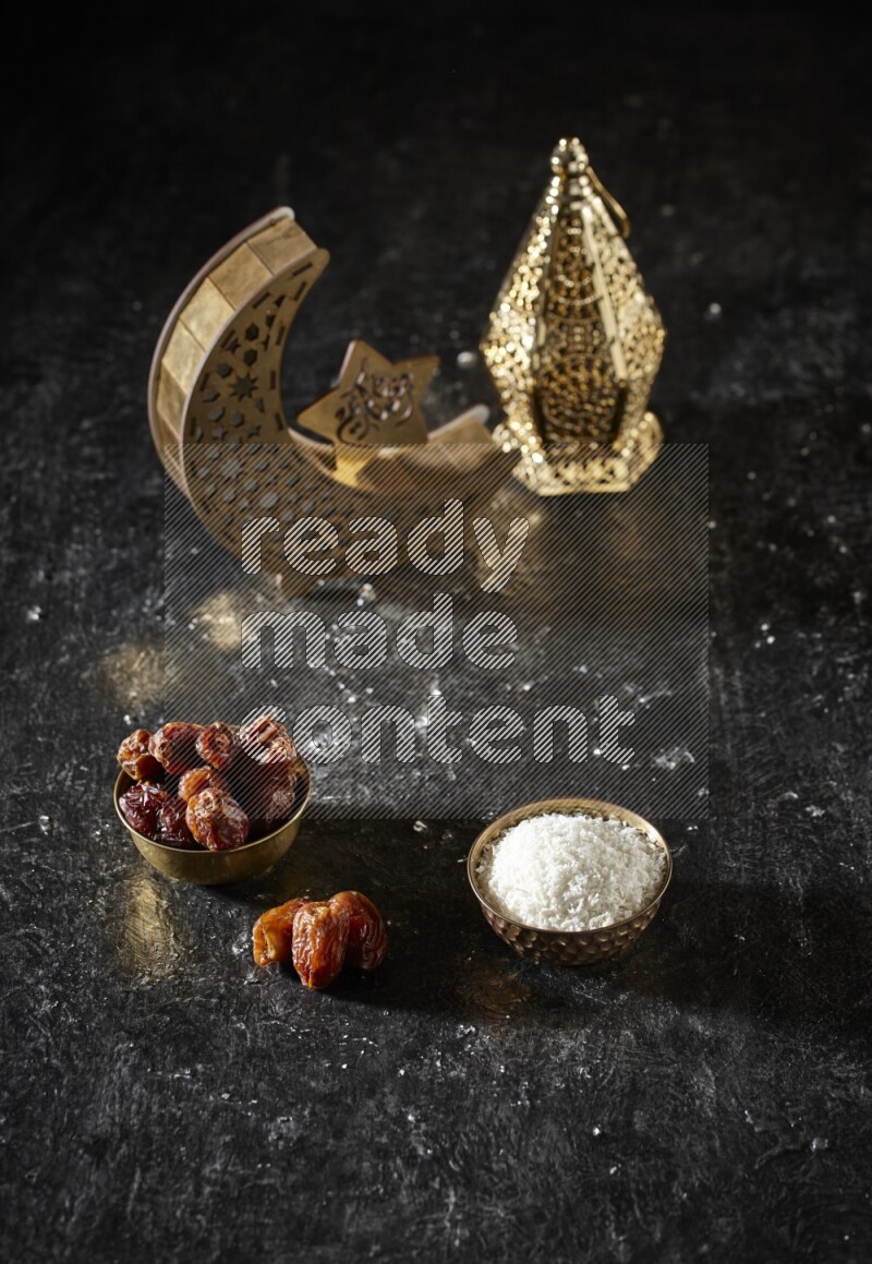 تمر في وعاء معدني مع جوز الهند المجفف بجانب فوانيس ذهبية علي خلفية سوداء