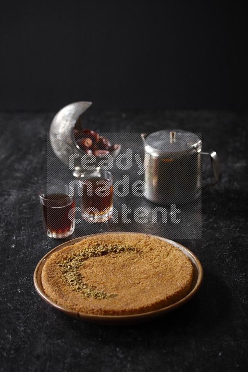 konafa with tea in a dark setup