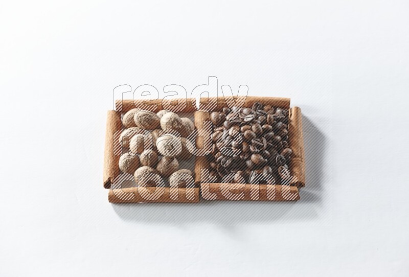 2 squares of cinnamon sticks full of coffee beans and nutmegs on white flooring