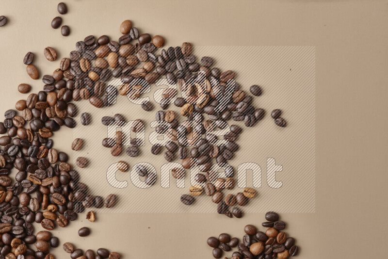 Roasted coffee beans on beige background