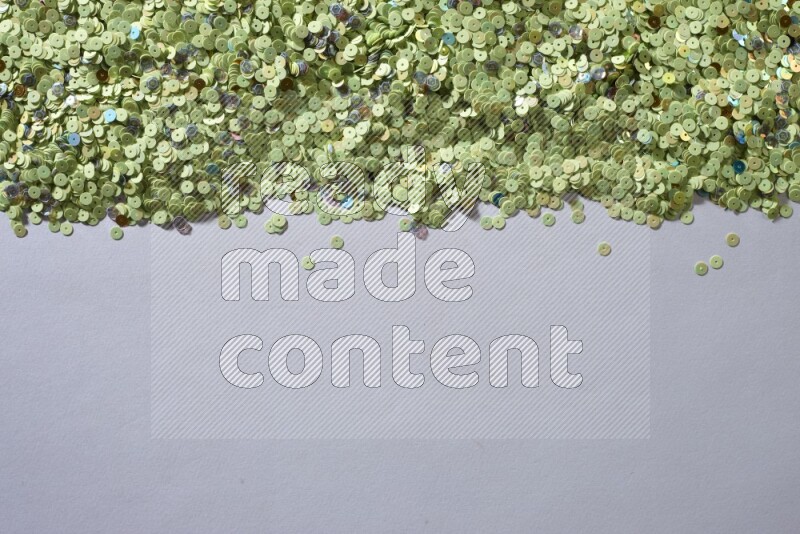 Multicolored flat sequins on grey background