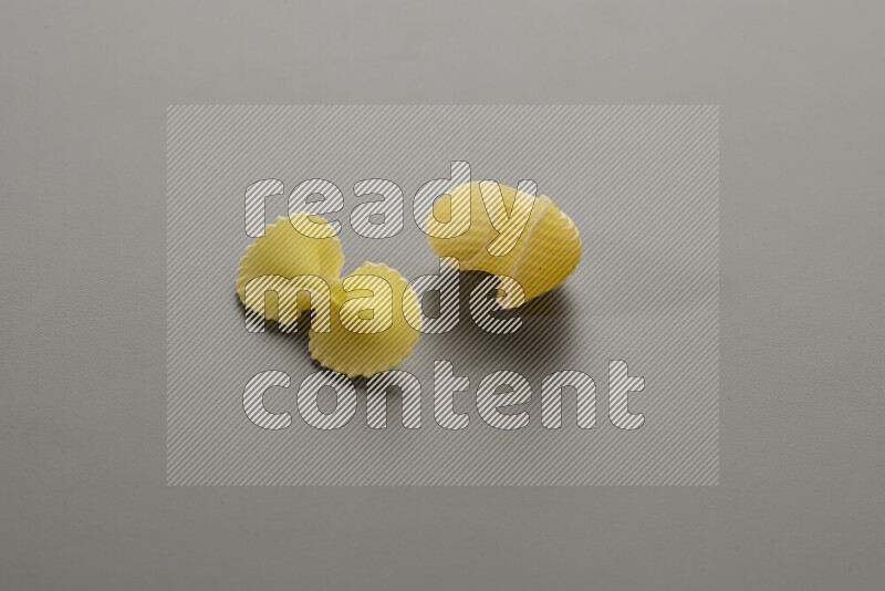 Fiocchi pasta with other types of pasta on grey background