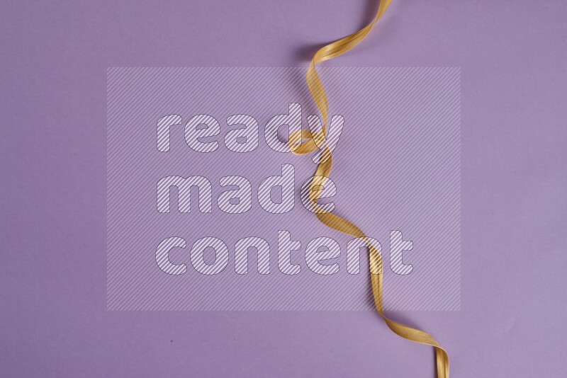 A yellow and purple collection of sewing and tailoring tools arranged on a purple background