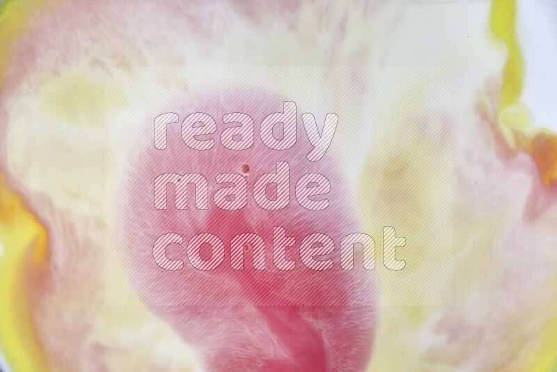 A close-up of abstract swirling patterns in yellow, red and white