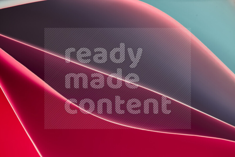 This image showcases an abstract paper art composition with paper curves in green and red gradients created by colored light