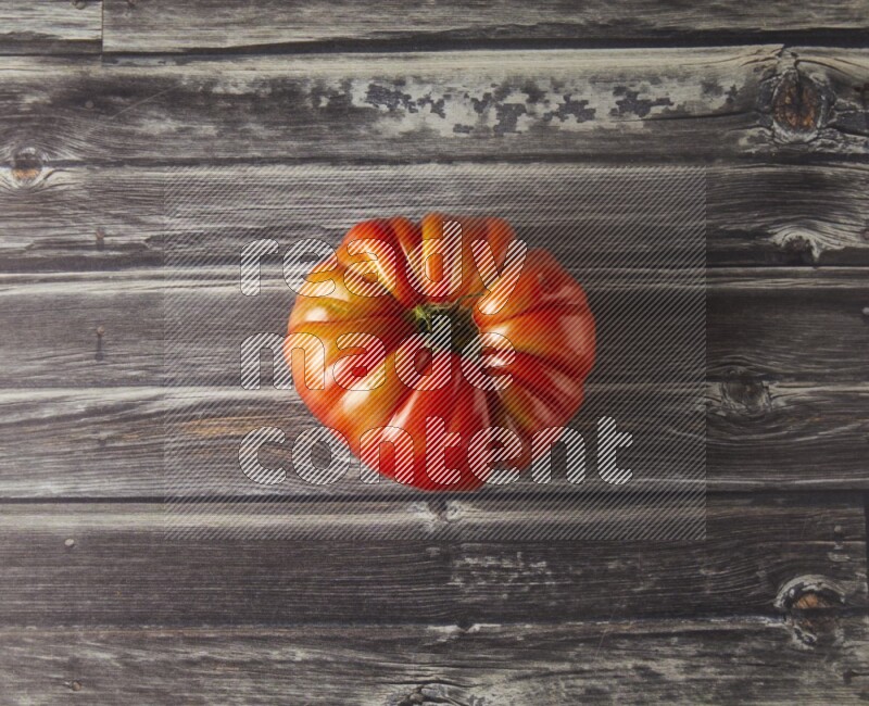 Single Tipview Heirloom Tomato on grey wooden background