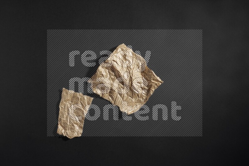 Crumpled craft paper on black background
