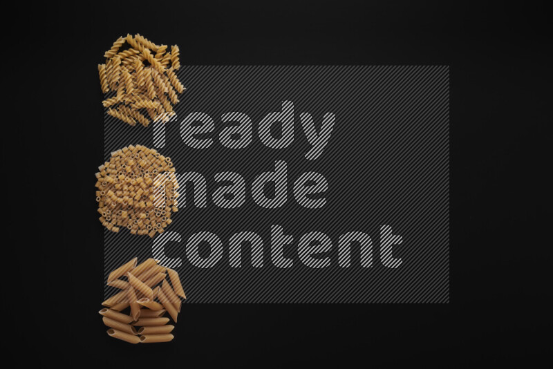 Different pasta types in 3 bunches on black background