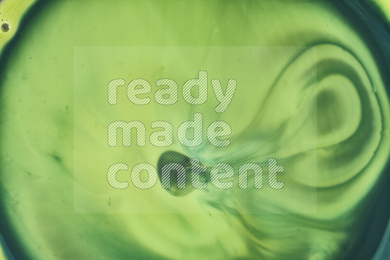 A close-up of abstract swirling patterns in green gradients