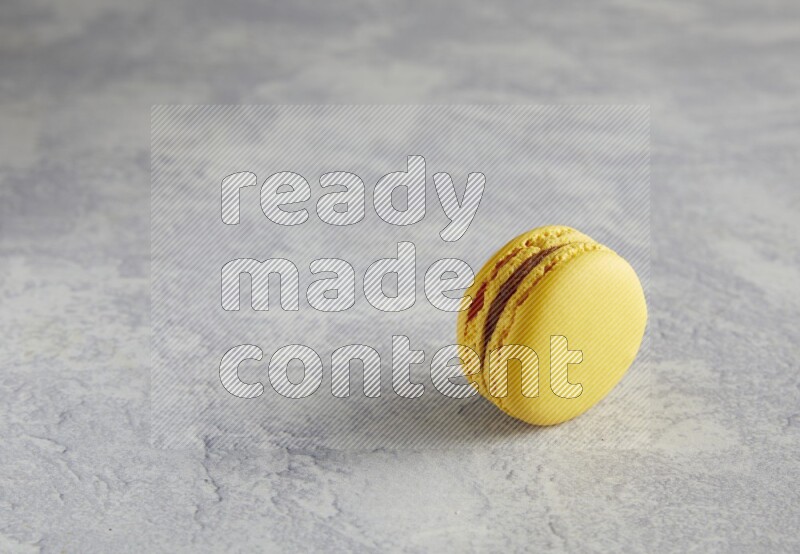 45º Shot of Yellow Lemon macaron on white  marble background
