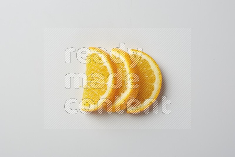 Three halves of an orange slices on white background