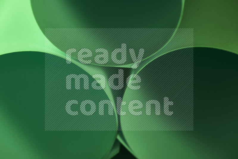The image shows an abstract paper art with circular shapes in varying shades of green