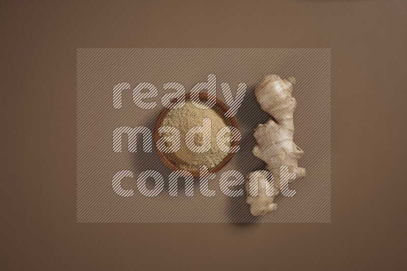 Fresh ginger root with different ingredients such as lemon, orange, honey, ground ginger on beige baackground