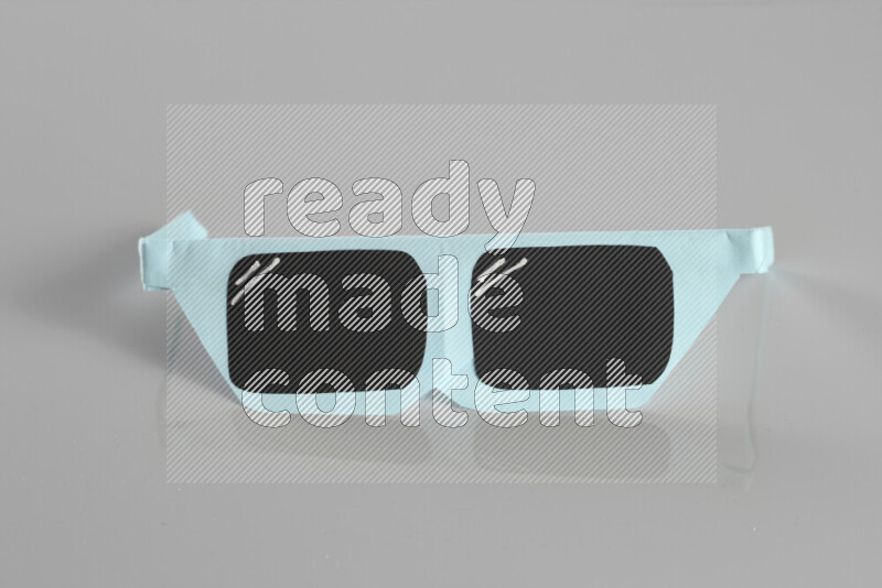 Origami sun glasses on grey background