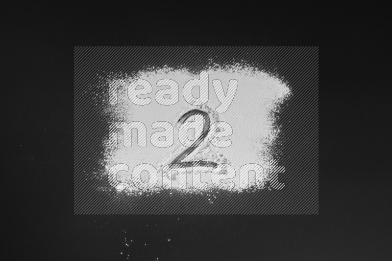 Numbers written with powder on black background