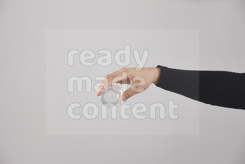 امرأة ترتدي عباءة سوداء تحمل أدوات زجاجية مختلفة في أوضاع متعددة