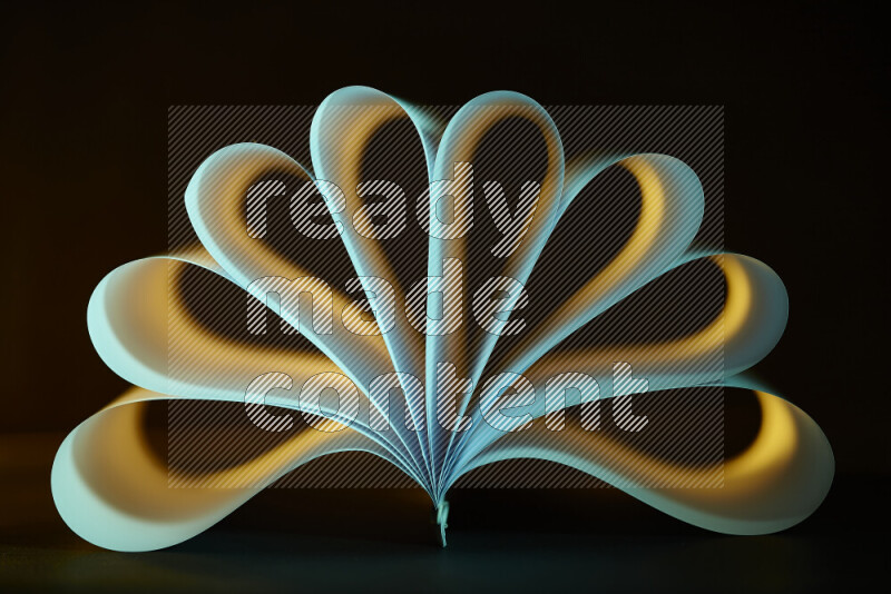 An abstract art piece displaying smooth curves in yellow and green gradients created by colored light