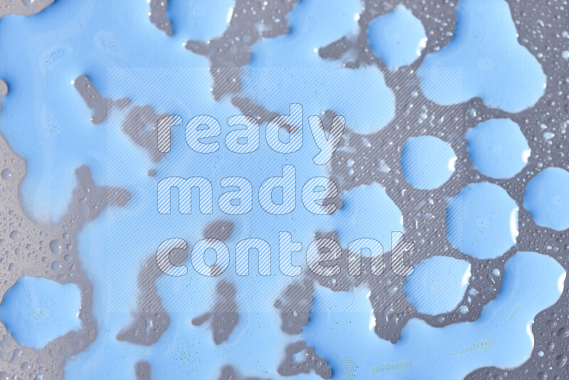 Close-ups of abstract blue paint droplets on the surface