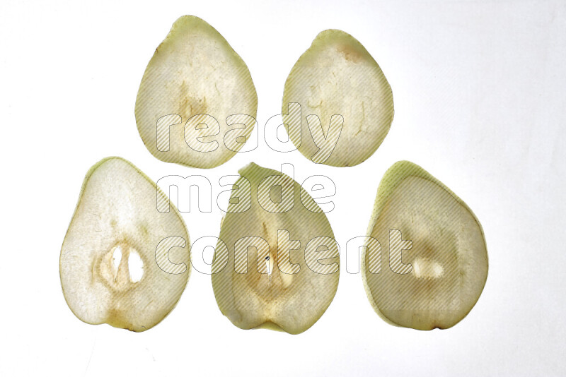 Pear slices on illuminated white background
