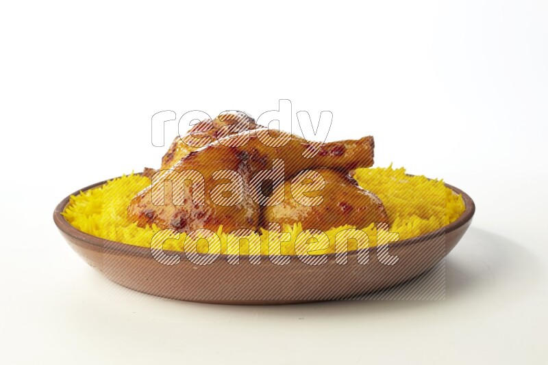 yellow basmati Rice with kabsa chicken pieces on a pottery plate direct on white background
