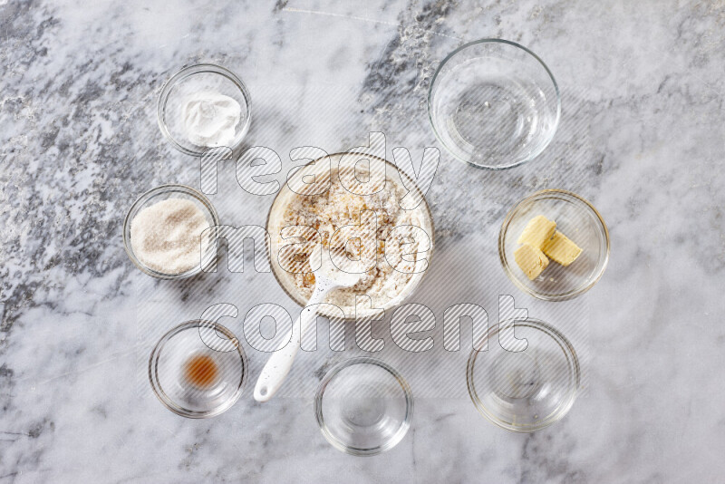 Cookies step by step with its ingredient, flour, butter, brown sugar, egg, vanilla extract, white sugar, chocolate chips and baking soda on grey marble background