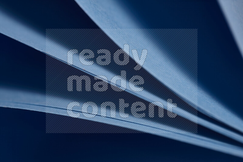 An abstract art showing blue paper sheets arranged in an overlapping curves