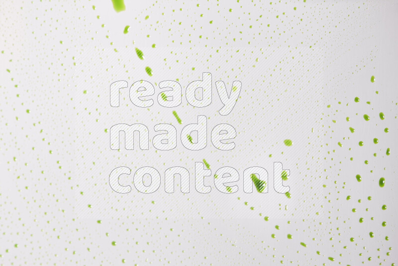 Close-ups of abstract green paint droplets on the surface