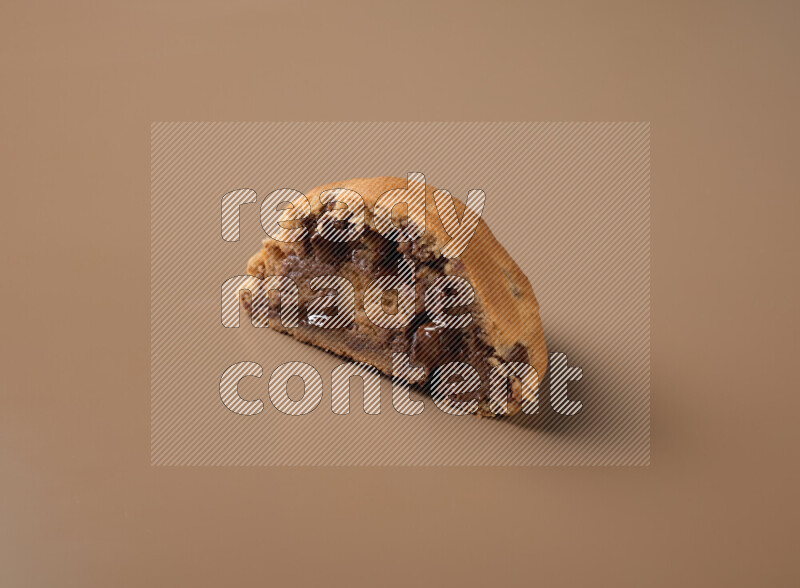 a cookie cut in half on a brown background