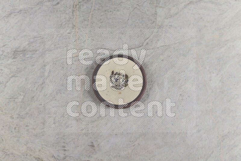 A decorative pottery plate on grey marble background