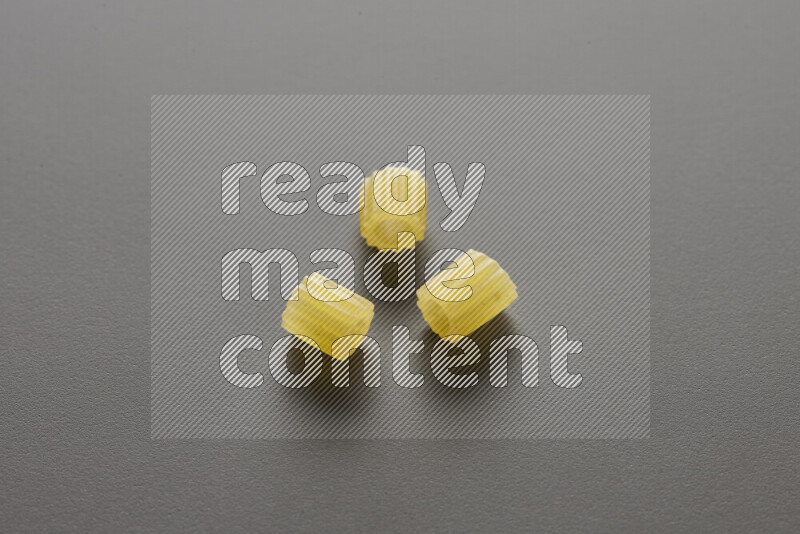 Small rings pasta on grey background