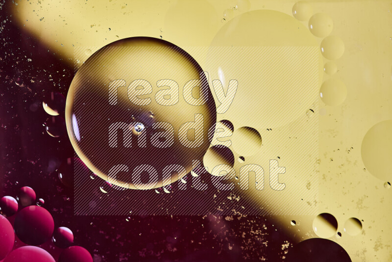 Close-ups of abstract oil bubbles on water surface in shades of red and yellow