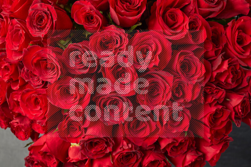 A luxurious bouquet of red roses on black marble background