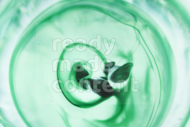 A close-up of abstract swirling patterns in green gradients