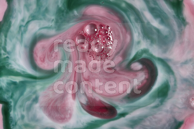 A close-up of abstract swirling patterns in red and green