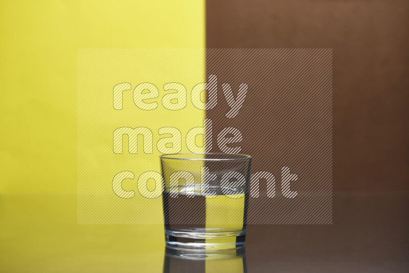 The image features a clear glassware filled with water, set against yellow and brown background