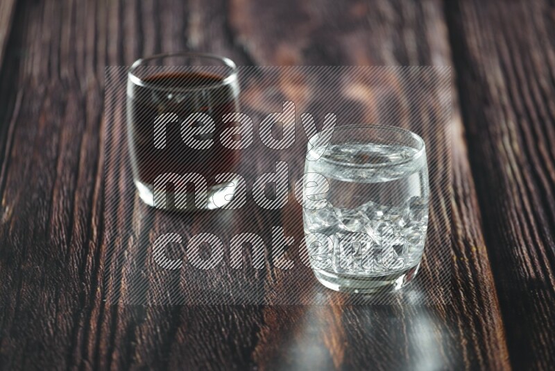 Cold drinks in a glass cup such as water, tamarind, qamar eldin, sobia, milk and hibiscus on wooden background