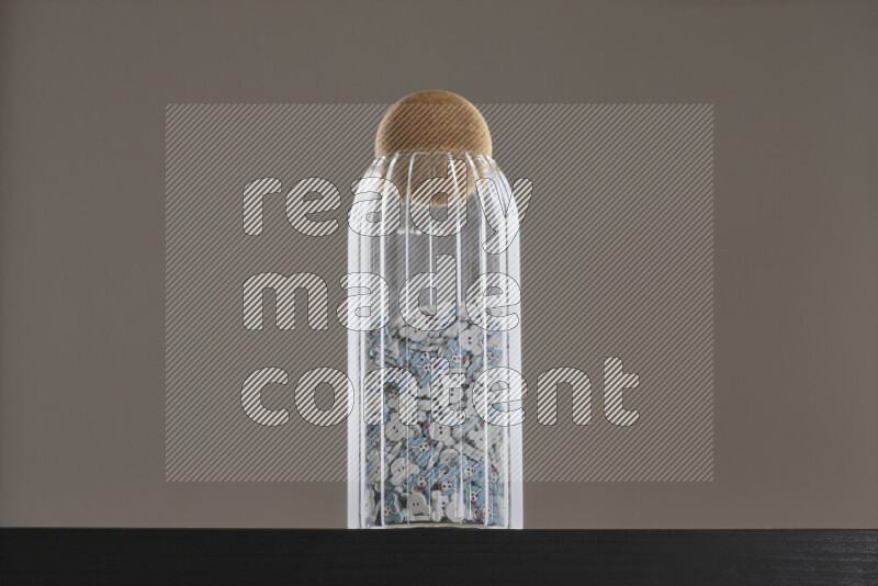 Buttons in a glass jar on black background
