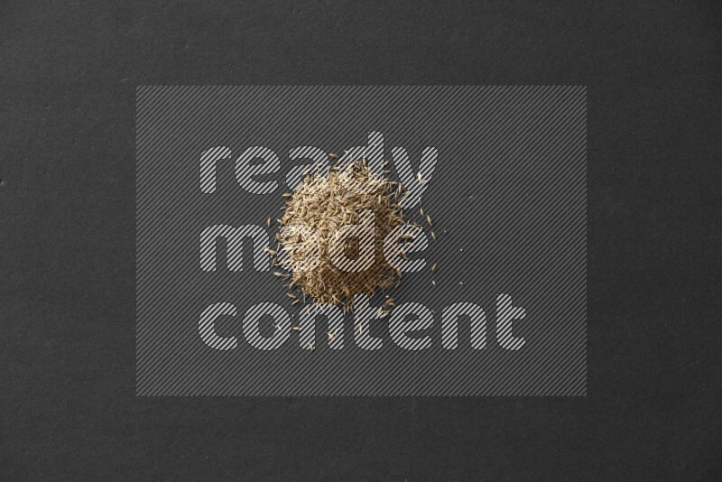 Cumin on a black flooring