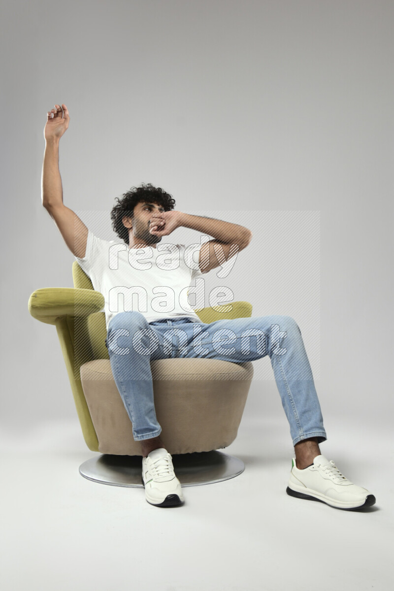 A man wearing casual sitting on a chair making a hand gesture on white background