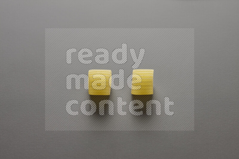 Big rings pasta on grey background