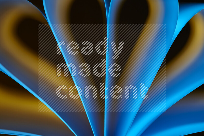 An abstract art piece displaying smooth curves in yellow and blue gradients created by colored light