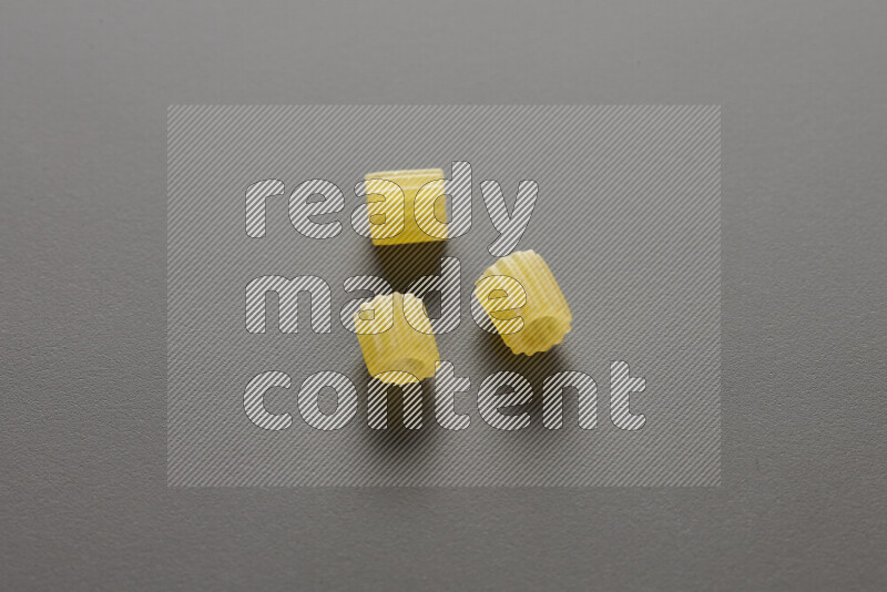 Small rings pasta on grey background
