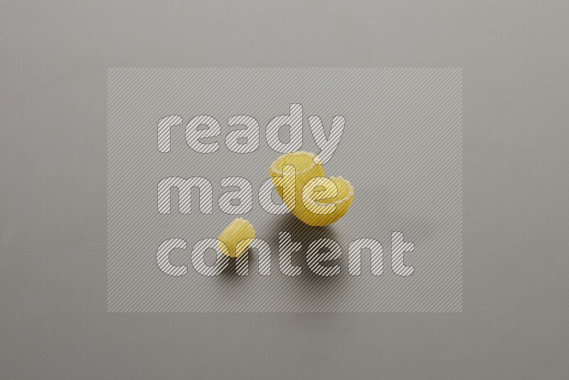 Small rings pasta with other types of pasta on grey background