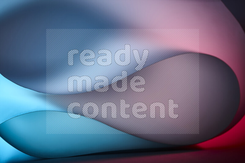 فن تجريدي يعرض منحنيات وتدرجات اللون الأزرق والأحمر مكونه بضوء ملون