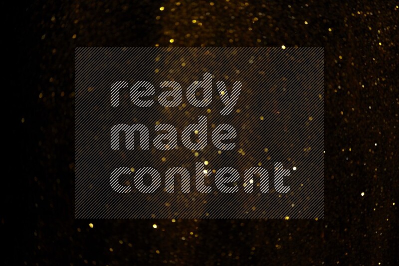 Gold glitter powder isolated on black background