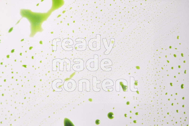 Close-ups of abstract green paint droplets on the surface